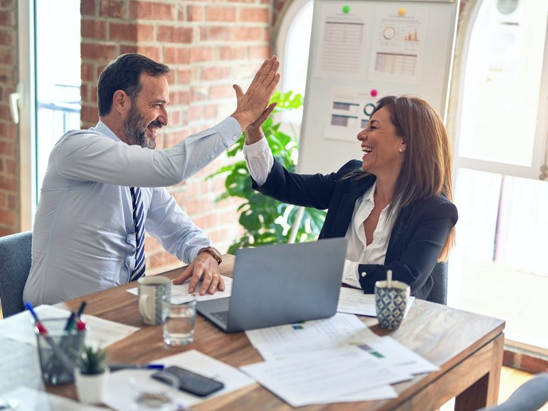 Business partners celebrating a successful consulting partnership
